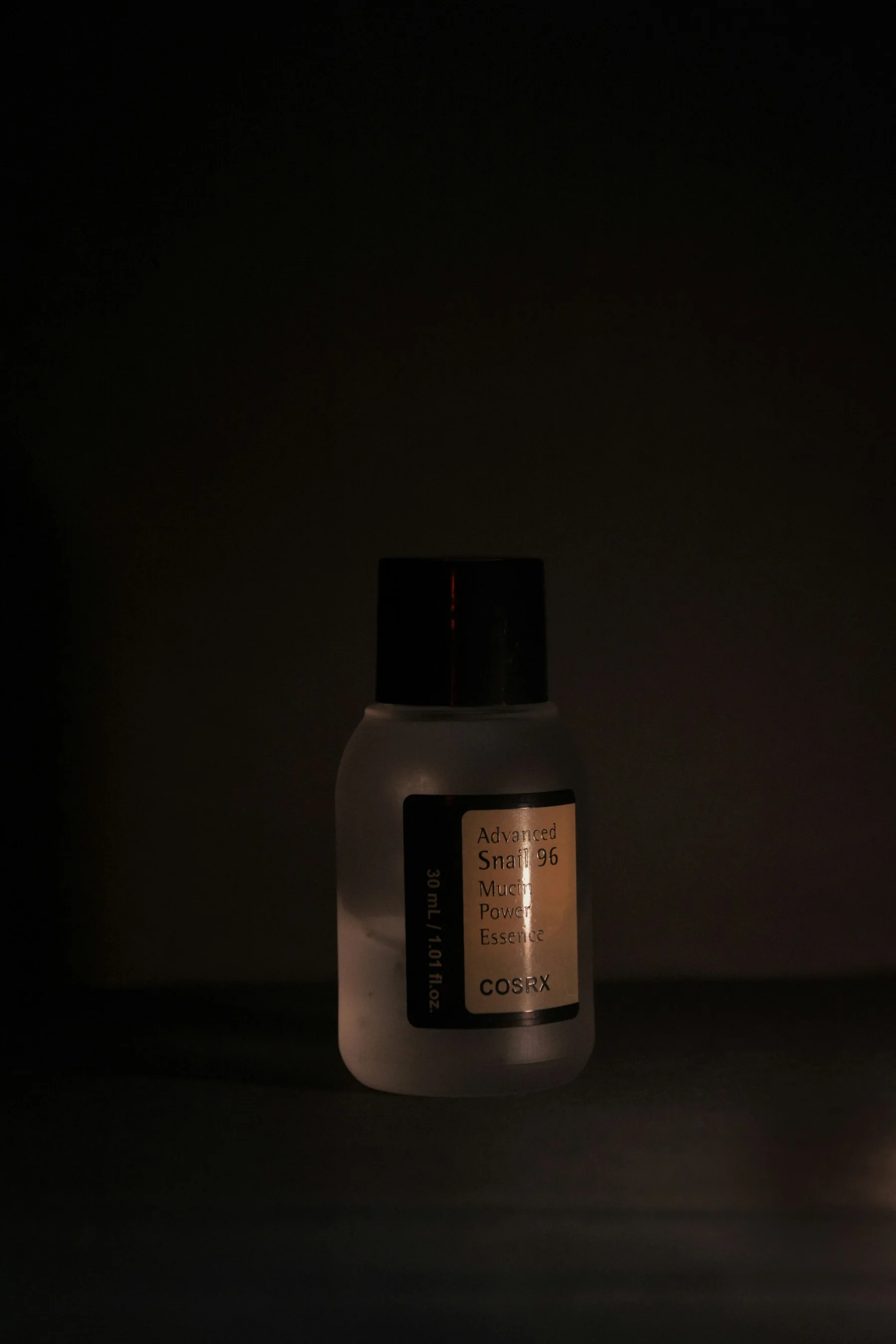 Skincare product photographed in a dramatic studio setting